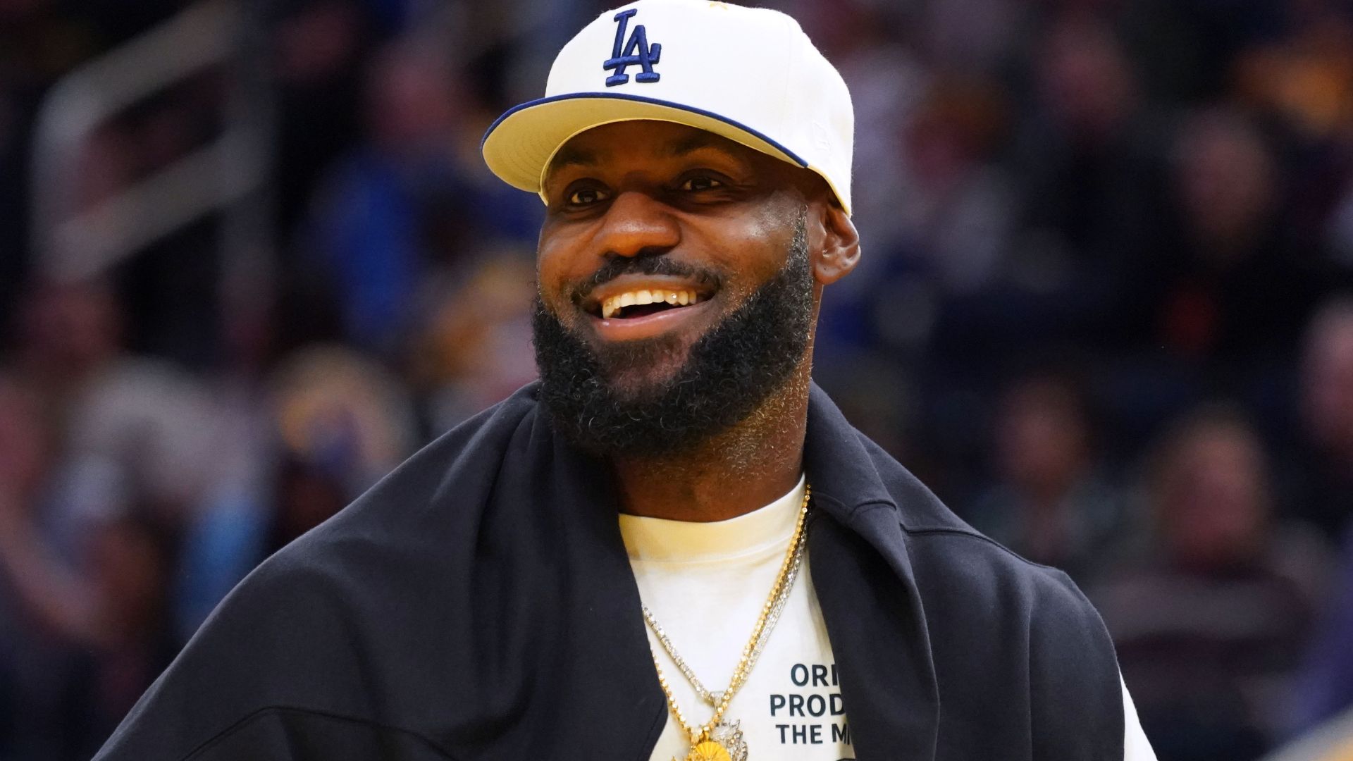 Oct 5, 2025; San Francisco, California, USA; Los Angeles Lakers forward LeBron James (23), wearing a Los Angeles Dodgers hat, watches from the sideline during a break against the Golden State Warriors in the third quarter at Chase Center.