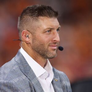 SEC Network analyst Tim Tebow on the field before a game between the Tennessee Volunteers and Syracuse Orange at Mercedes-Benz Stadium.