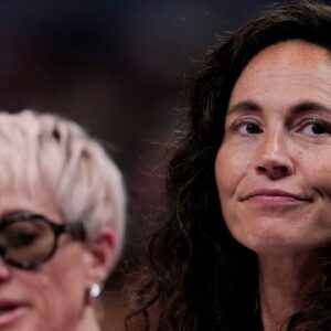 Megan Rapinoe (left) sits next to her wife, Sue Bird, on Friday, July 18, 2025, during the WNBA All-Star 3-point and skills contests at Gainbridge Fieldhouse in Indianapolis.