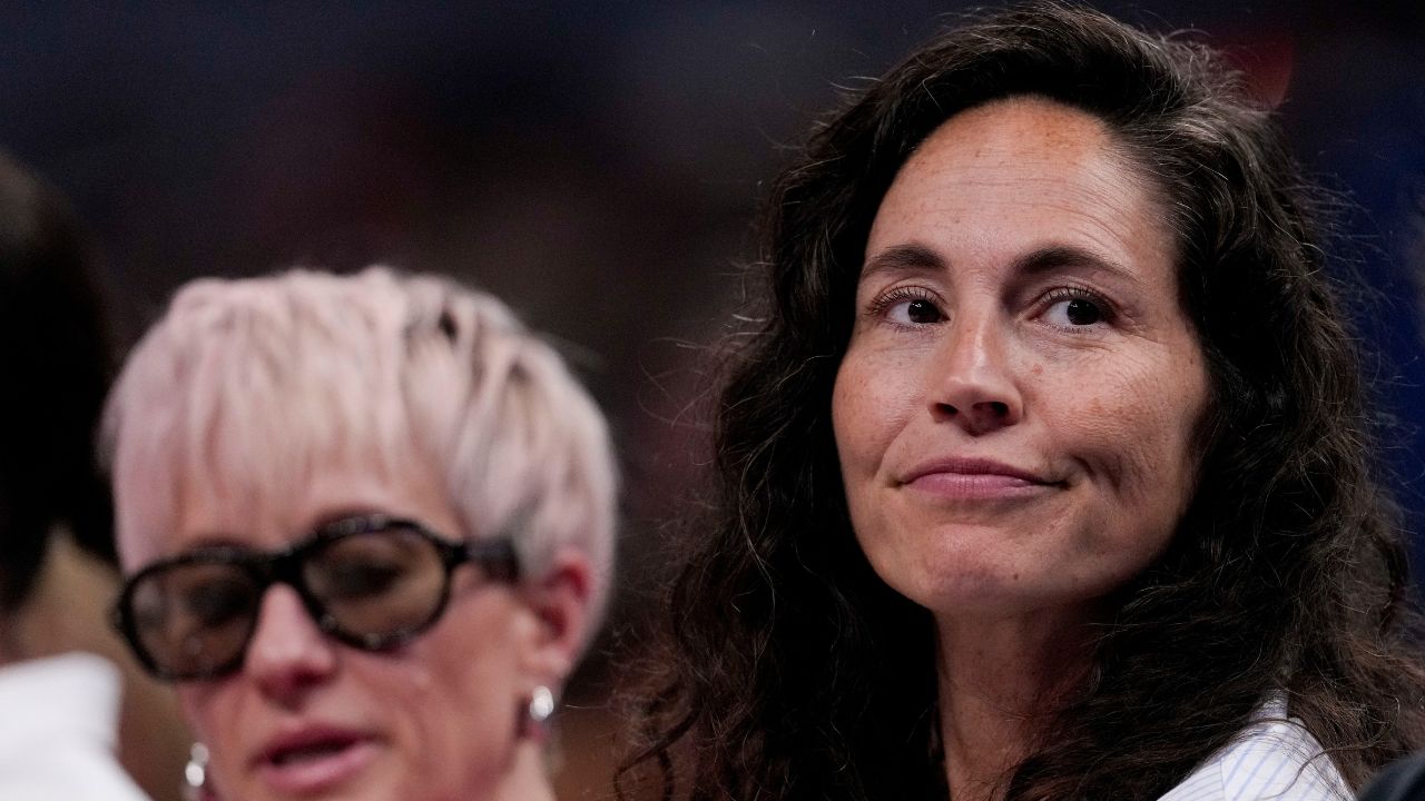 Megan Rapinoe (left) sits next to her wife, Sue Bird, on Friday, July 18, 2025, during the WNBA All-Star 3-point and skills contests at Gainbridge Fieldhouse in Indianapolis.