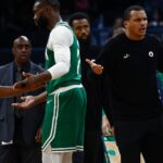 Oct 22, 2025; Boston, Massachusetts, USA; As Boston Celtics guard Jaylen Brown (7) talks with referee Michael Smith (38), head coach Joe Mazzulla gestures towards another official after Brown was called for a charge during the second half against the Philadelphia 76ers at TD Garden