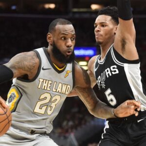 Feb 25, 2018; Cleveland, OH, USA; Cleveland Cavaliers forward LeBron James (23) drives to the basket against San Antonio Spurs guard Dejounte Murray (5) during the first half at Quicken Loans Arena.