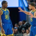 Golden State Warriors guard Stephen Curry (30) speaks with forward Jonathan Kuminga (00) during a time out against the Minnesota Timberwolves during the fourth quarter at Chase Center.
