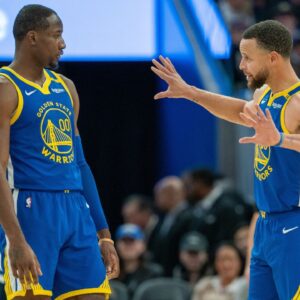 Golden State Warriors guard Stephen Curry (30) speaks with forward Jonathan Kuminga (00) during a time out against the Minnesota Timberwolves during the fourth quarter at Chase Center.