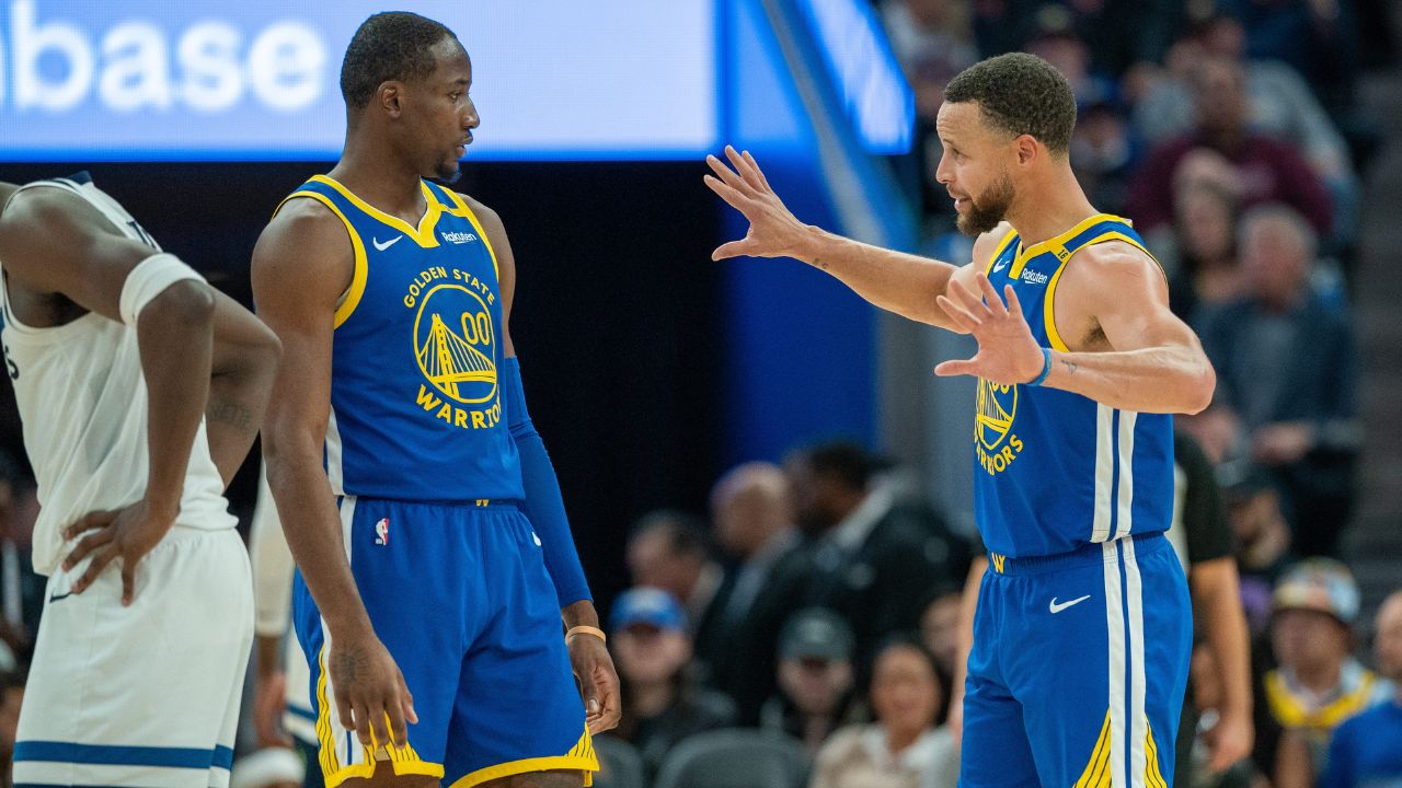 Golden State Warriors guard Stephen Curry (30) speaks with forward Jonathan Kuminga (00) during a time out against the Minnesota Timberwolves during the fourth quarter at Chase Center.