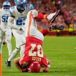 Kansas City Chiefs tight end Travis Kelce (87) leaps over Detroit Lions cornerback Rock Ya-Sin (23) against the Detroit Lions during the first half at GEHA Field at Arrowhead Stadium.