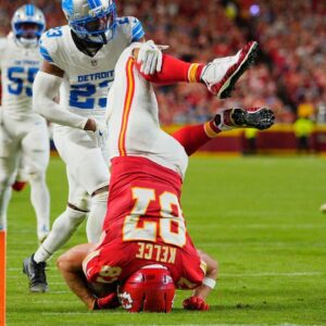 Kansas City Chiefs tight end Travis Kelce (87) leaps over Detroit Lions cornerback Rock Ya-Sin (23) against the Detroit Lions during the first half at GEHA Field at Arrowhead Stadium.