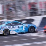 Oct 5, 2025; Concord, North Carolina, USA; NASCAR Cup Series driver Ross Chastain (1) backs across the finish line at Charlotte Motor Speedway Road Course