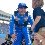 Nov 2, 2025; Avondale, Arizona, USA; NASCAR Cup Series driver Kyle Larson (5) celebrates his championship victory with son Cooper following the Cup Series Championship race at Phoenix Raceway