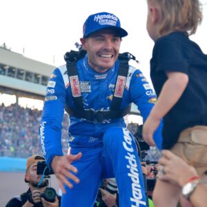 Nov 2, 2025; Avondale, Arizona, USA; NASCAR Cup Series driver Kyle Larson (5) celebrates his championship victory with son Cooper following the Cup Series Championship race at Phoenix Raceway