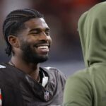 Cleveland Browns quarterback Shedeur Sanders (12) is all smiles as he chats on the sideline during the second half of an NFL football game at Huntington Bank Field, Nov. 16, 2025, in Cleveland, Ohio.