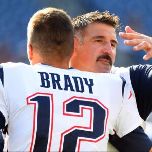 New England Patriots quarterback Tom Brady (12) hugs Tennessee Titans head coach Mike Vrabel before the preseason game at Nissan Stadium.