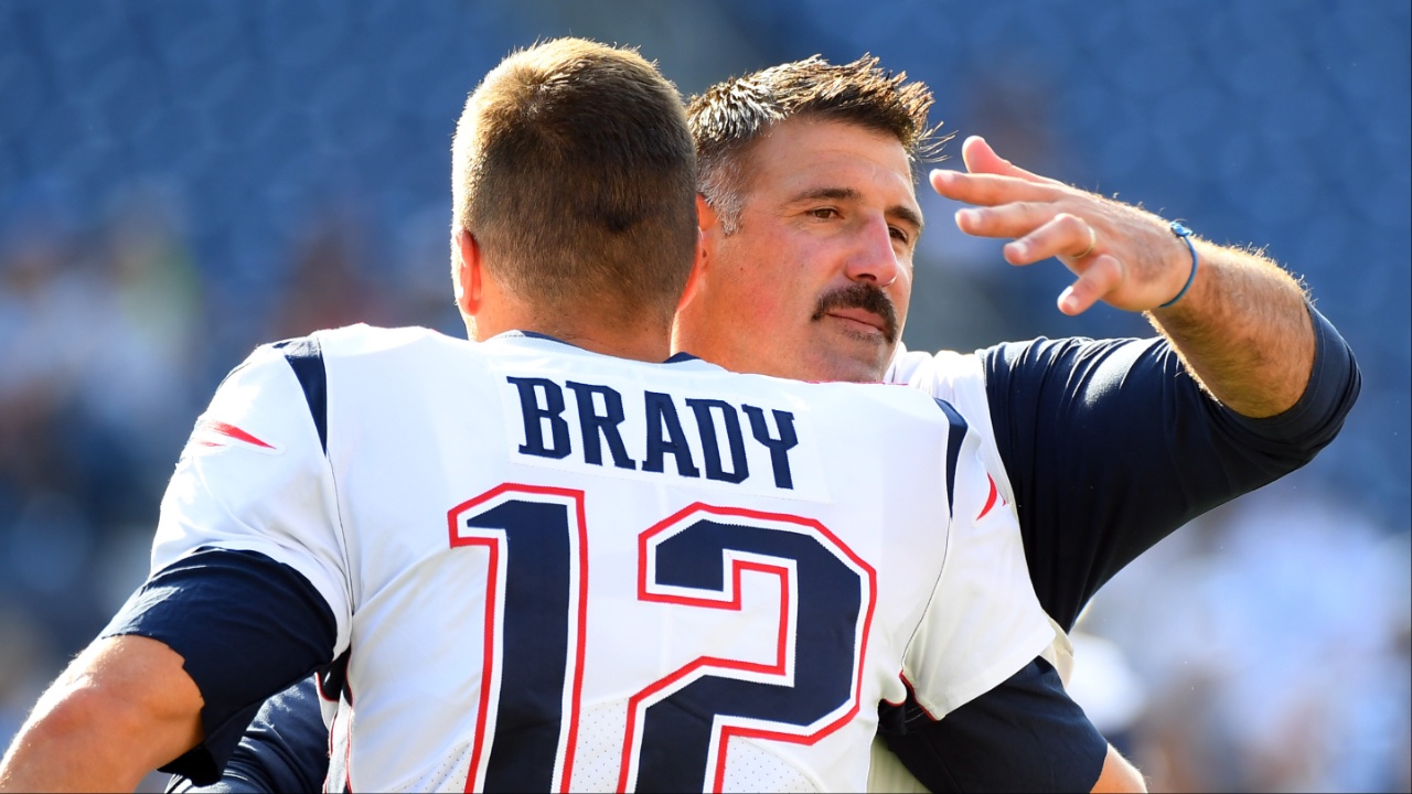 New England Patriots quarterback Tom Brady (12) hugs Tennessee Titans head coach Mike Vrabel before the preseason game at Nissan Stadium.