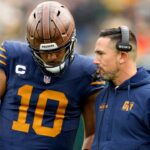 Green Bay Packers head coach Matt LaFleur talks to quarterback Jordan Love (10) during the second half against the Carolina Panthers at Lambeau Field.