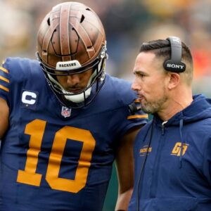 Green Bay Packers head coach Matt LaFleur talks to quarterback Jordan Love (10) during the second half against the Carolina Panthers at Lambeau Field.