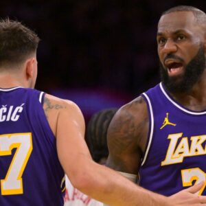 Nov 25, 2025; Los Angeles, California, USA; Los Angeles Lakers guard Luka Doncic (77) and forward LeBron James (23) react after a foul during the first half against the Los Angeles Clippers at Crypto.com Arena