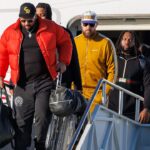 Kansas City Chiefs tight end Travis Kelce (87) exits the plane after arriving at Louis Armstrong New Orleans International Airport.