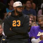 Los Angeles Lakers forward Lebron James (23) looks on from the bench during the first half against the Golden State Warriors at Crypto.com Arena.