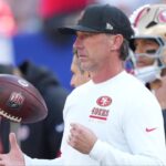 San Francisco 49ers head coach Kyle Shanahan tosses a football in the air during warm ups prior to a game against the New York Giants at MetLife Stadium.