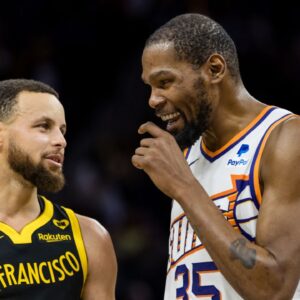 Golden State Warriors guard Stephen Curry (30) and Phoenix Suns forward Kevin Durant (35) talk during the second half at Chase Center.