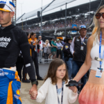 May 26, 2024; Indianapolis, Indiana, USA; Indycar Series driver Kyle Larson holds son Cooper Larson as he walks with daughter Audrey Larson, wife Katelyn Larson and son Owen Larson prior to the 108th running of the Indianapolis 500 at Indianapolis Motor Speedway. Mandatory Credit: Mark J. Rebilas-Imagn Images