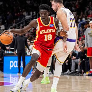 Nov 8, 2025; Atlanta, Georgia, USA; Atlanta Hawks forward Mouhamed Gueye (18) dribbles against Los Angeles Lakers guard Luka Doncic (77) during the second half at State Farm Arena.