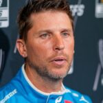 Aug 27, 2025; Charlotte, NC, USA; Denny Hamlin answers questions from the media during NASCAR Cup Series Playoff Media Day at Charlotte Convention Center.