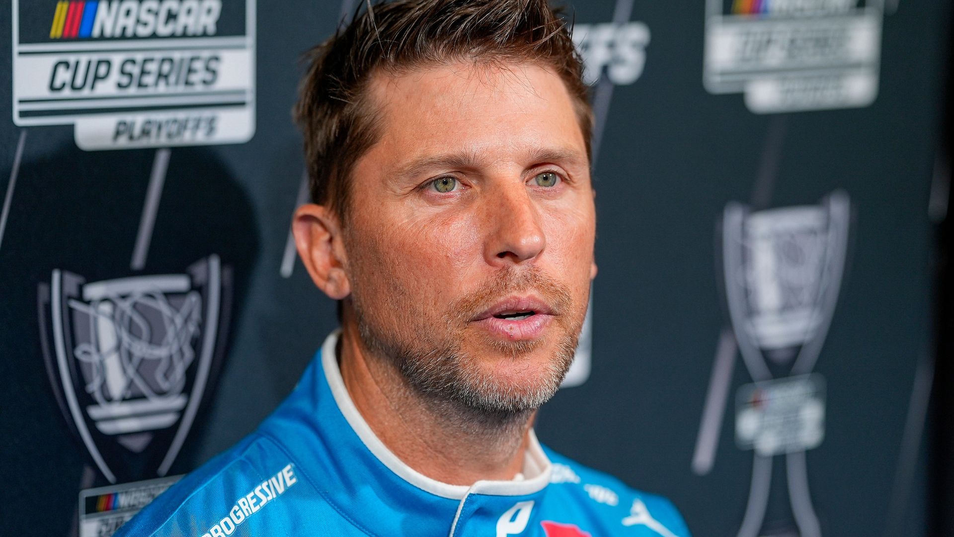 Aug 27, 2025; Charlotte, NC, USA; Denny Hamlin answers questions from the media during NASCAR Cup Series Playoff Media Day at Charlotte Convention Center.