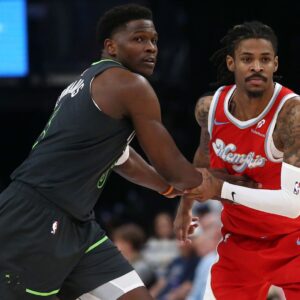 Apr 10, 2025; Memphis, Tennessee, USA; Minnesota Timberwolves guard Anthony Edwards (5) and Memphis Grizzlies guard Ja Morant (12) battle for position during the third quarter at FedExForum