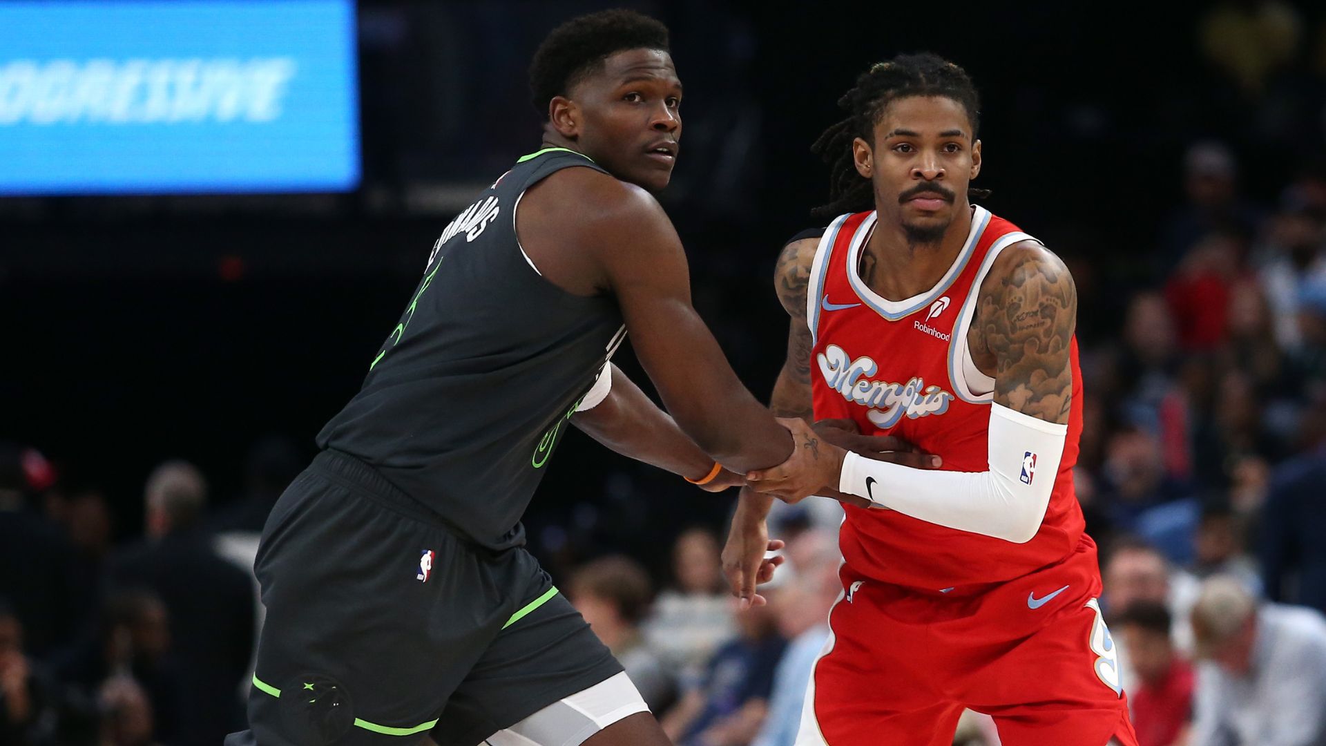 Apr 10, 2025; Memphis, Tennessee, USA; Minnesota Timberwolves guard Anthony Edwards (5) and Memphis Grizzlies guard Ja Morant (12) battle for position during the third quarter at FedExForum