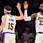 Mar 22, 2025; Los Angeles, California, USA; Los Angeles Lakers forward LeBron James (23) fives guard Austin Reaves (15) after scoring against the Chicago Bulls during the second half at Crypto.com Arena.