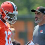 Cleveland Browns quarterback Shedeur Sanders speaks with coach Kevin Stefanski during practice at minicamp June 11, 2025, in Berea, Ohio.