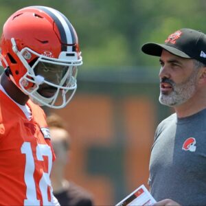 Cleveland Browns quarterback Shedeur Sanders speaks with coach Kevin Stefanski during practice at minicamp June 11, 2025, in Berea, Ohio.