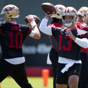 San Francisco 49ers quarterbacks Mac Jones (10) and Brock Purdy (13) work on passing drills during a team OTA at Levi's Stadium.