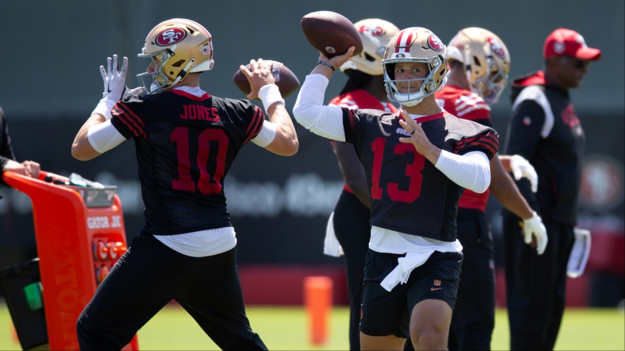 San Francisco 49ers quarterbacks Mac Jones (10) and Brock Purdy (13) work on passing drills during a team OTA at Levi's Stadium.