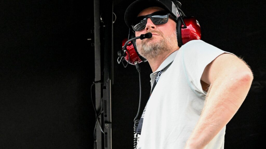 Dale Earnhardt Jr. looks out from his pit box Saturday, July 26, 2025, during the Pennzoil 250 at Indianapolis Motor Speedway.