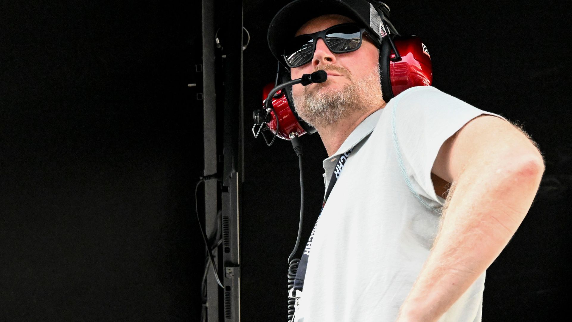 Dale Earnhardt Jr. looks out from his pit box Saturday, July 26, 2025, during the Pennzoil 250 at Indianapolis Motor Speedway.