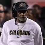 Colorado Buffaloes head coach Deion Sanders looks on during a time out in the game against the Utah Utes during the second quarter at Rice-Eccles Stadium.