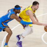 Oklahoma City Thunder guard Shai Gilgeous-Alexander (2) reaches to steal the ball from Los Angeles Lakers guard Luka Doncic (77) during the second half at Paycom Center.