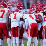 Members of the Kansas City Chiefs offensive squad huddle in the second quarter against the Denver Broncos at Empower Field at Mile High.