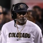Colorado Buffaloes head coach Deion Sanders looks on during a time out in the game against the Utah Utes during the second quarter at Rice-Eccles Stadium.