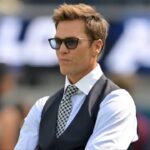 Tom Brady looks on before the game between the Los Angeles Chargers and the Washington Commanders at SoFi Stadium.
