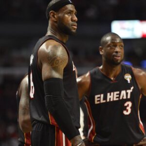 Miami Heat forward LeBron James (L) and guard Dwyane Wade stand on the court during the third quarter against the Chicago Bulls at the United Center in Chicago on March 27, 2013