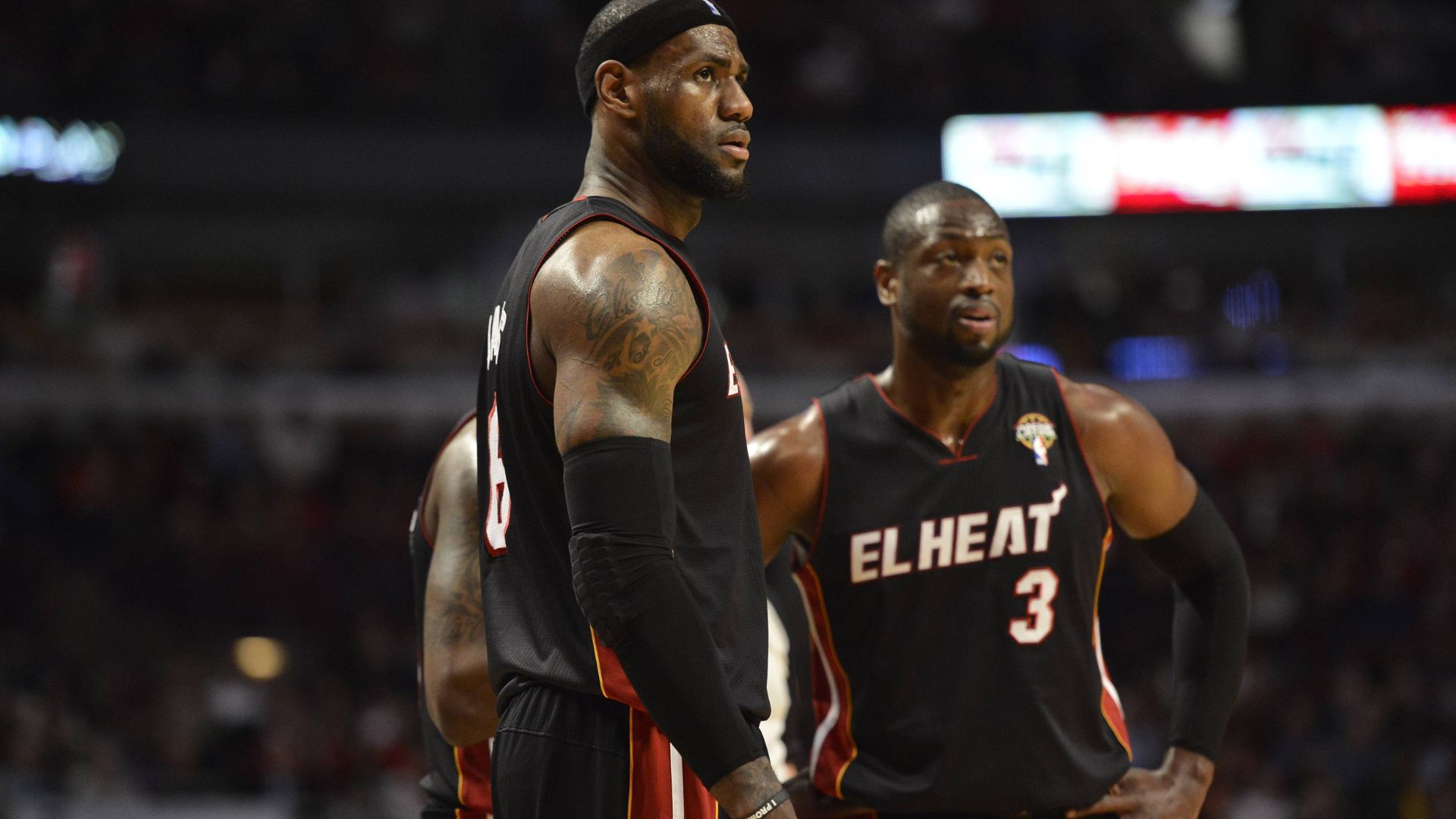 Miami Heat forward LeBron James (L) and guard Dwyane Wade stand on the court during the third quarter against the Chicago Bulls at the United Center in Chicago on March 27, 2013
