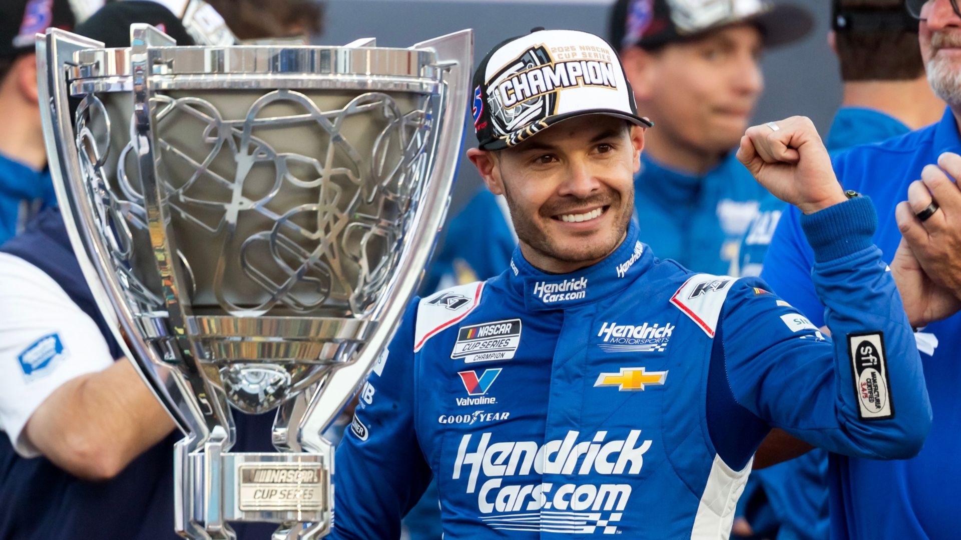 Nov 2, 2025; Avondale, Arizona, USA; NASCAR Cup Series driver Kyle Larson (5) celebrates with the Bill France Cup trophy after clinching the 2025 NASCAR Cup Series Championship following the NASCAR Championship race at Phoenix Raceway.