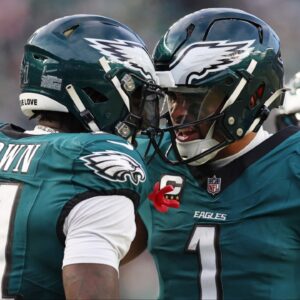 Philadelphia Eagles quarterback Jalen Hurts (1) and wide receiver A.J. Brown (11) celebrate after a touchdown against the Washington Commanders during the first half in the NFC Championship game at Lincoln Financial Field.