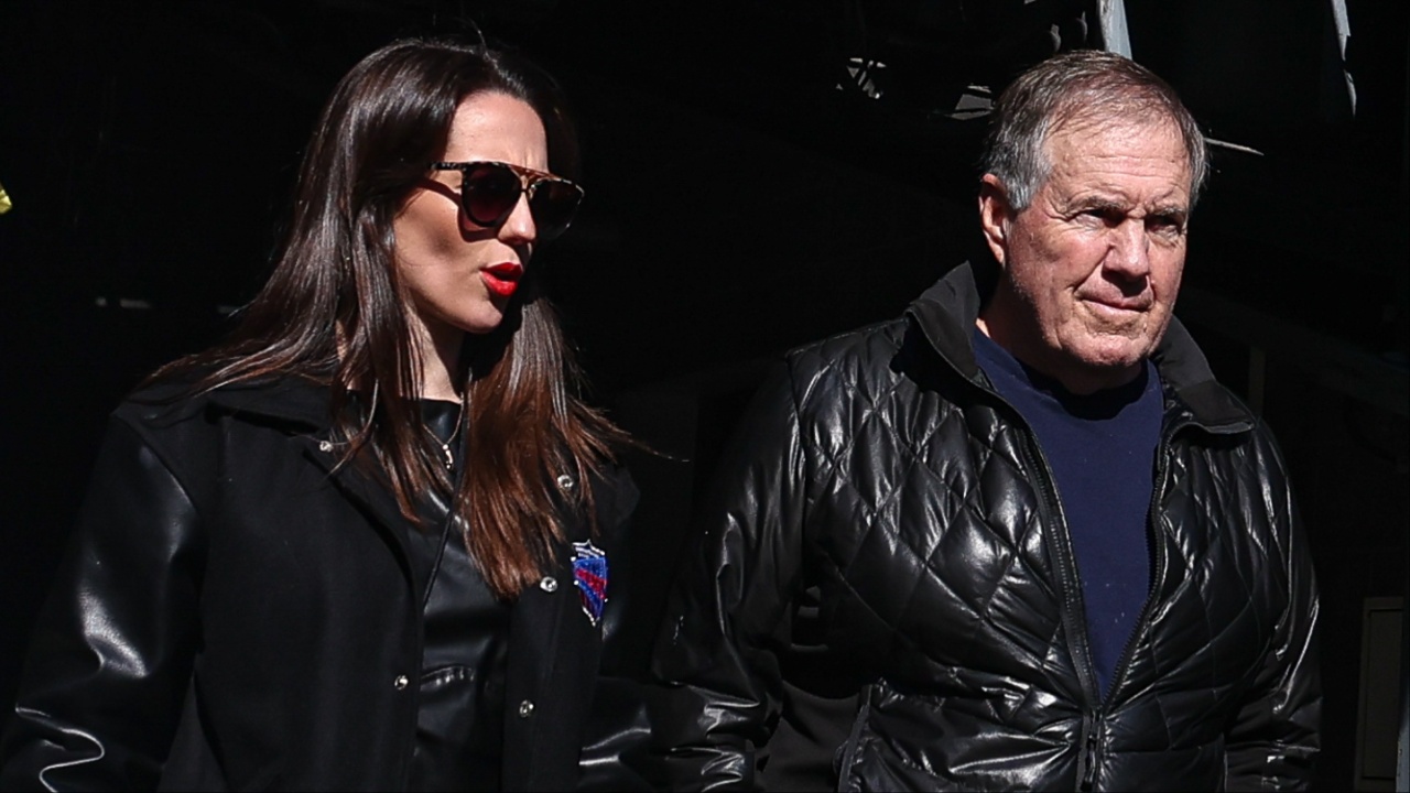 Former New England Patriots head coach Bill Belichick and girlfriend Jordon Hudson enter the field before the game between the Notre Dame Fighting Irish and the Navy Midshipmen at MetLife Stadium.