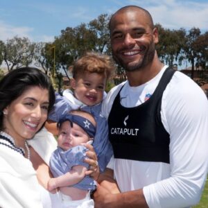 Dallas Cowboys quarterback Dak Prescott poses with fiancee Sarah Jane Ramos and daughters MJ Rose Prescott and Aurora Prescott at training camp at the River Ridge Fields.