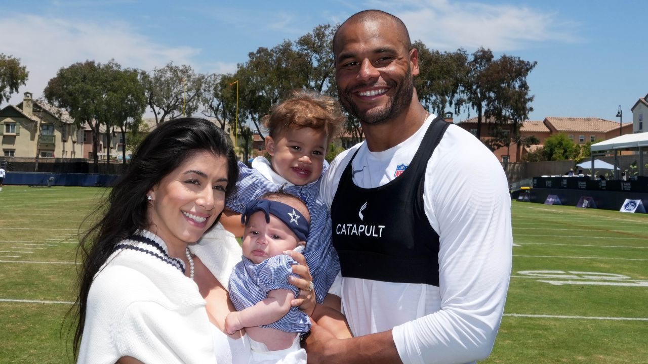 Dallas Cowboys quarterback Dak Prescott poses with fiancee Sarah Jane Ramos and daughters MJ Rose Prescott and Aurora Prescott at training camp at the River Ridge Fields.