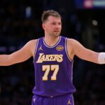 Nov 28, 2025; Los Angeles, California, USA; Los Angeles Lakers guard Luka Doncic (77) reacts after a foul on Dallas Mavericks forward Naji Marshall (13) in the second half at Crypto.com Arena